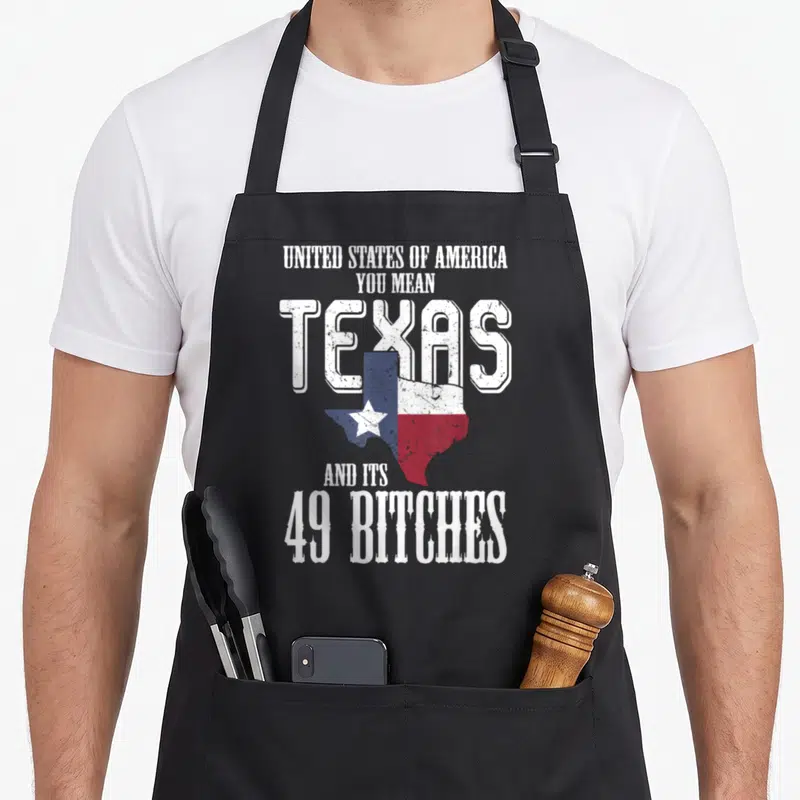 State texas flag apron - Stacked white text 49 bitches overlapped by Texas state map filled with red white and blue — shown on a black cotton canvas apron against a white background