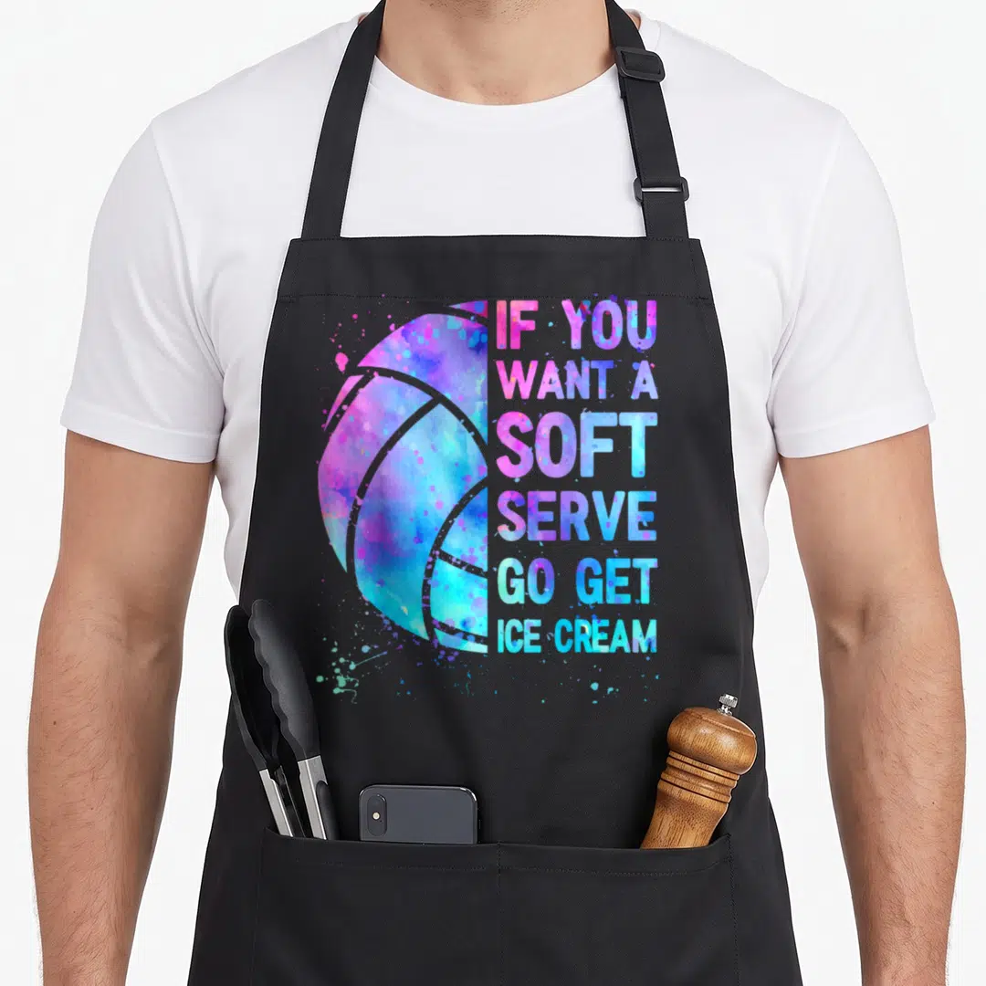 Volleyball to serve man apron - Watercolor volleyball in blue purple pink with text IF YOU WANT A SOFT SERVE GO GET ICE — shown on a black cotton canvas apron against a white background