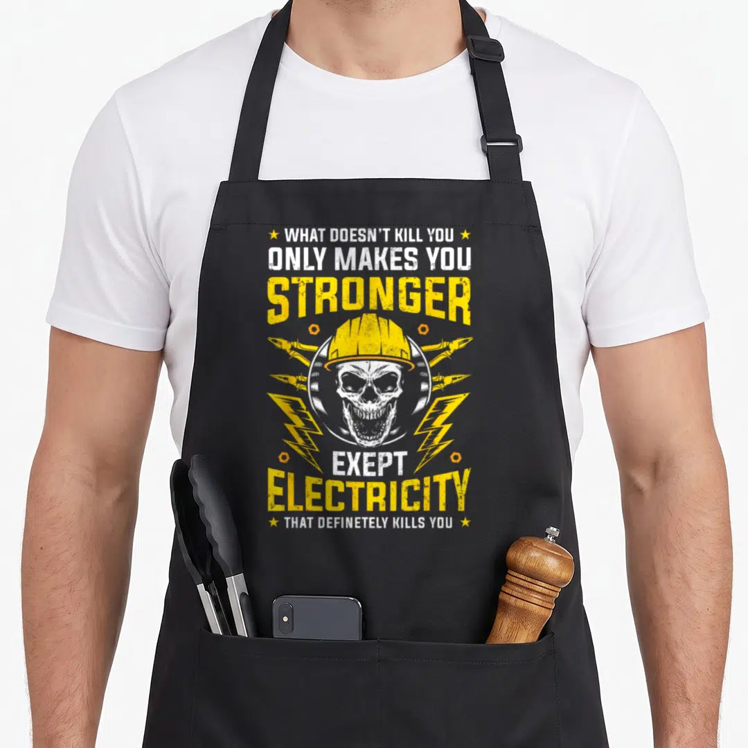 Kill funny craft apron - Distressed skull in hard hat with lightning bolts and sarcastic electrical safety quote — shown on a black cotton canvas apron against a white background