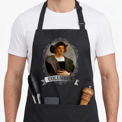 Christopher columbus apron - Portrait of Columbus in white oval frame with floral ornaments and COLUMBUS banner — shown on a black cotton canvas apron against a white background