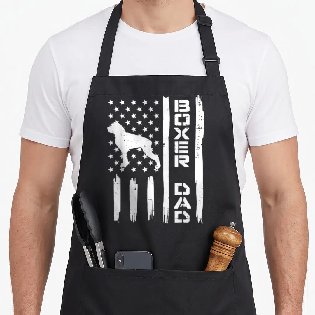 Flag patriotic boxer dog apron - White boxer dog silhouette on distressed flag with vertical BOXER DAD text — shown on a black cotton canvas apron against a white background