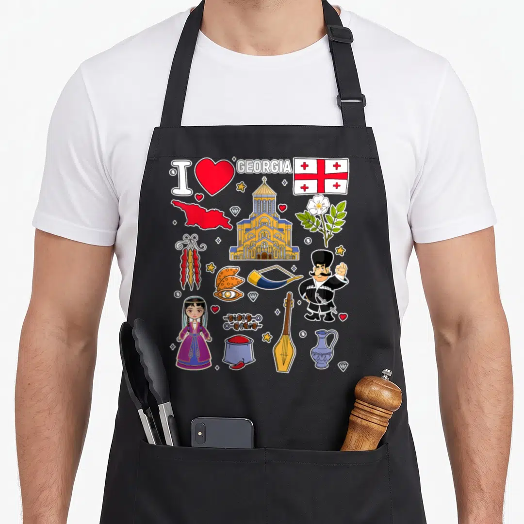 Hand georgian girl apron - Cartoon collage of Georgia map, flag, traditional girl, and cultural symbols in red and gold — shown on a black cotton canvas apron against a white background