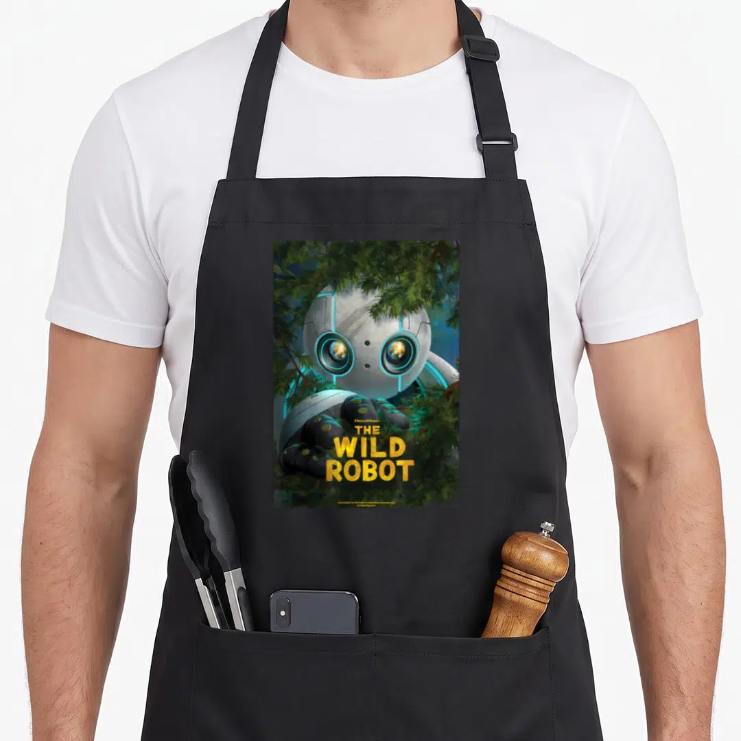 Movie young wild apron - Robot head and hand peeking through green pine needles with yellow stacked title text — shown on a black cotton canvas apron against a white background