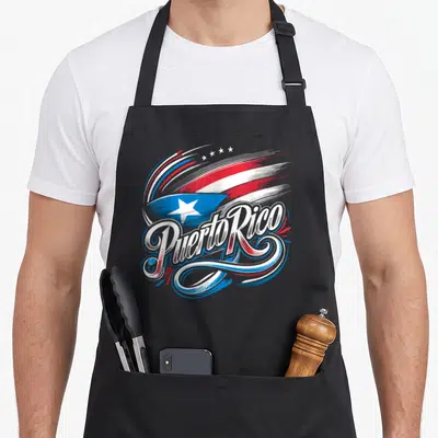 Rico heritage aprons - Stylized Puerto Rico flag text in red white blue brushstrokes with four stars — shown on a black cotton canvas apron against a white background
