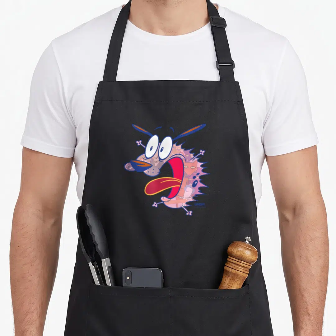 Evil dog apron - Cartoon dog head filled with monsters and a skull in pink, blue, purple, and orange — shown on a black cotton canvas apron against a white background