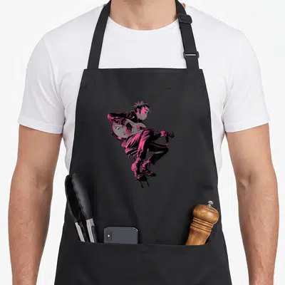 Gorillaz character aprons - Black and pink cartoon person sitting on a chair playing an electric guitar — shown on a black cotton canvas apron against a white background