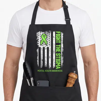 Fight mental health awareness apron - Distressed white flag with lime green ribbon and vertical Fight The Stigma text — shown on a black cotton canvas apron against a white background