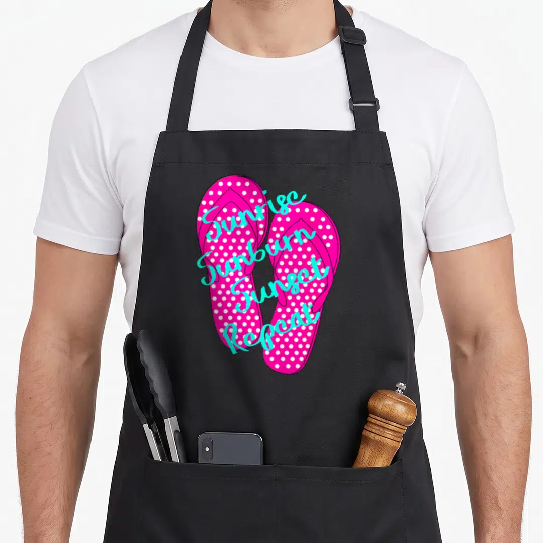 Sunrise country kitchen apron - Two pink polka dot flip flops with diagonal cyan text reading Sunrise Sunburn Sunset — shown on a black cotton canvas apron against a white background