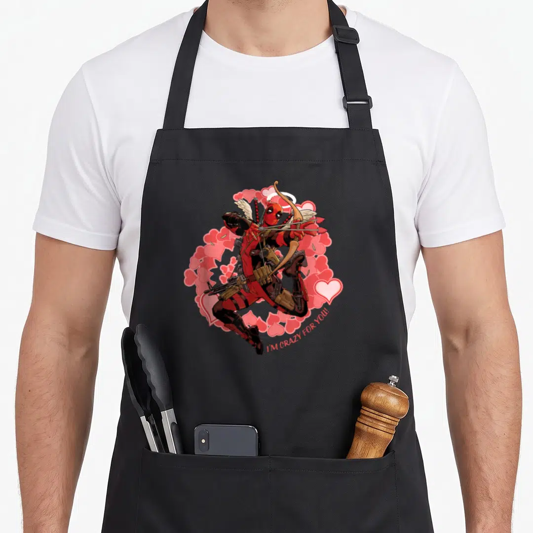 Animal valentine's day apron - Deadpool archer with wings and pink hearts, I'M CRAZY FOR YOU text — shown on a black cotton canvas apron against a white background