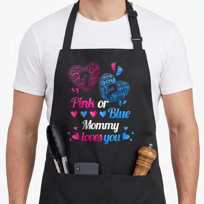 Blue family aprons - Pink and blue word cloud hearts spelling Girl and Boy with Pink or Blue Mommy loves you text — shown on a black cotton canvas apron against a white background