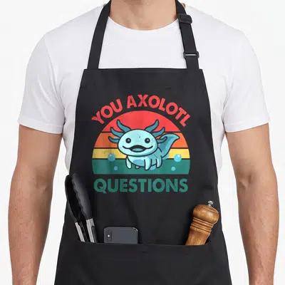 Question crazy axolotl man apron - Cartoon axolotl in front of striped sun with text YOU AXOLOTL QUESTIONS — shown on a black cotton canvas apron against a white background