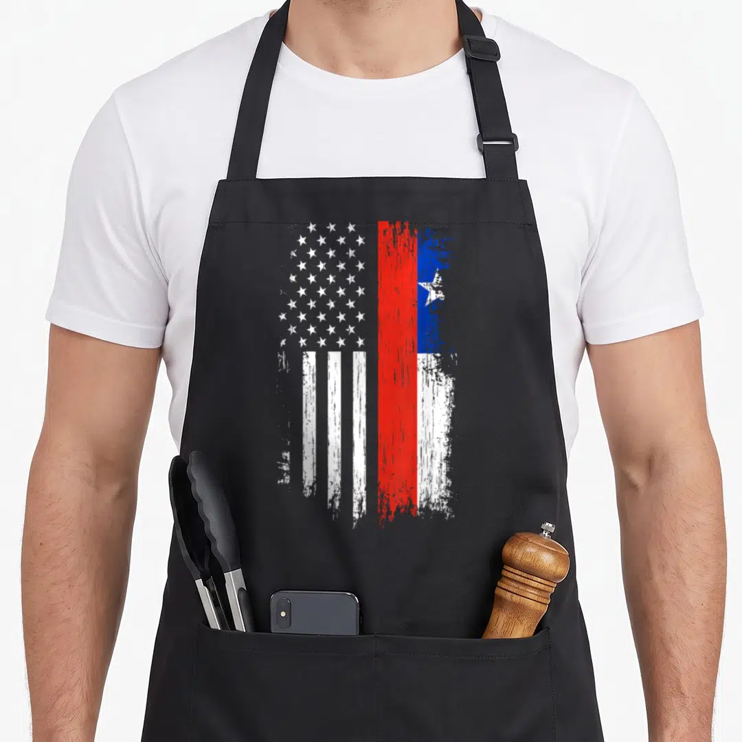Chilean american flag apron - Two merged flags in white red and blue with distressed texture showing heritage — shown on a black cotton canvas apron against a white background