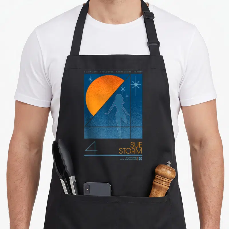 Studio fantastic four first steps apron - Sue Storm silhouette orange semi-circle blue stars scientists explorers — shown on a black cotton canvas apron against a white background