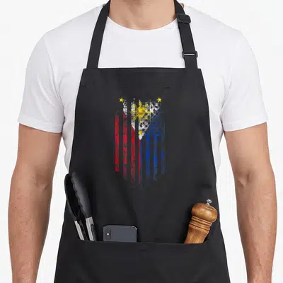 Funny filipino american flag apron - Distressed vertical flag with red blue white stripes and yellow sun stars on black — shown on a black cotton canvas apron against a white background