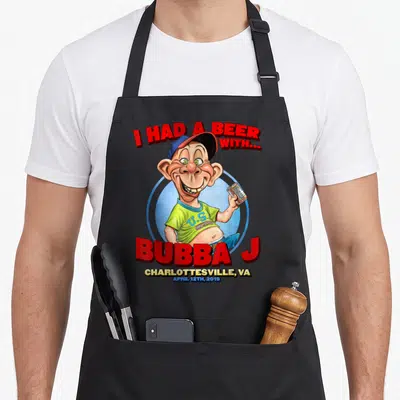 Bubba j apron - Cartoon man holding beer can with I Had A Beer text and Charlottesville date — shown on a black cotton canvas apron against a white background