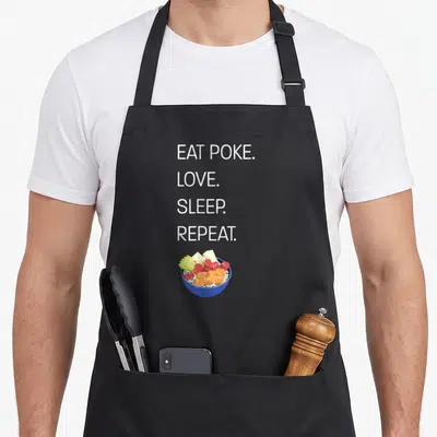 Eat hawaiian apron - Stacked white text EAT POKE LOVE SLEEP REPEAT above blue bowl with orange green and red food cubes — shown on a black cotton canvas apron against a white background