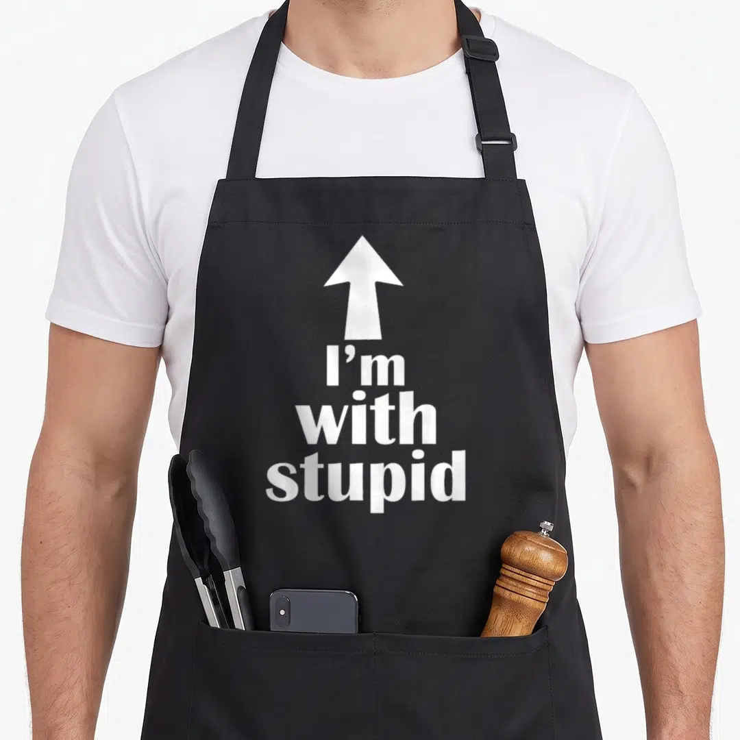 Arrow stupid aprons - White up arrow above I'm with stupid stacked text — shown on a black cotton canvas apron against a white background