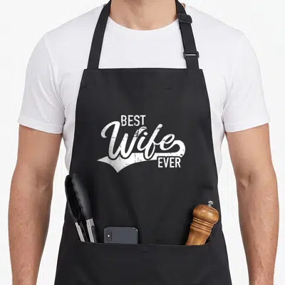 Retro wife apron - White stacked text reading Best Wife Ever in vintage script style — shown on a black cotton canvas apron against a white background