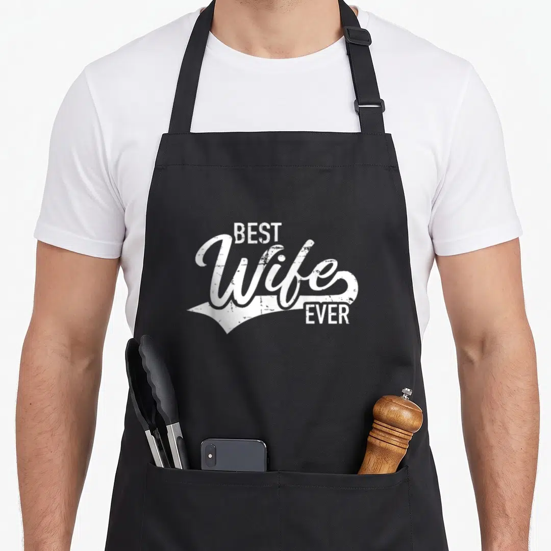 Retro wife apron - White stacked text reading Best Wife Ever in vintage script style — shown on a black cotton canvas apron against a white background