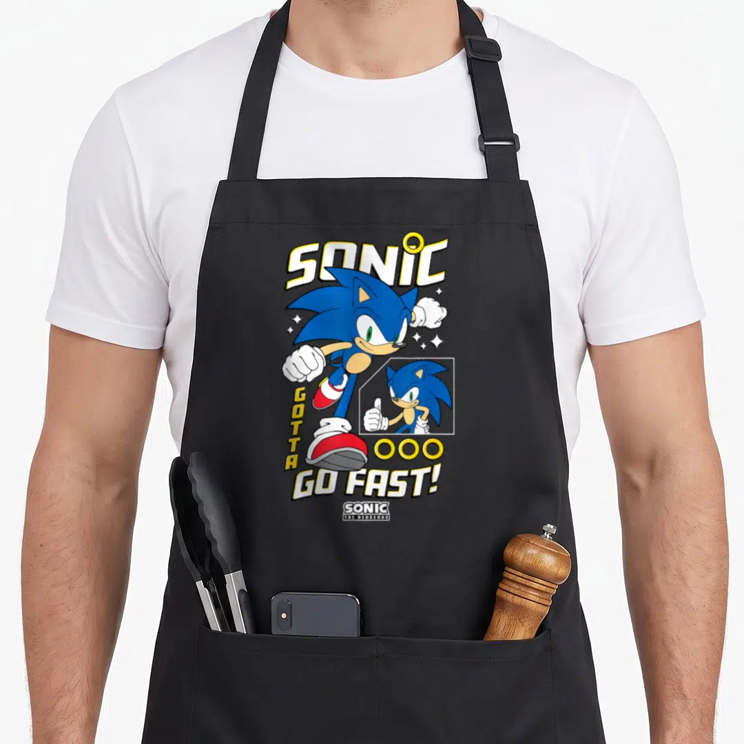 Fast crazy hedgehog man apron - Sonic action pose with vertical GOTTA text and horizontal GO FAST! lettering surrounded — shown on a black cotton canvas apron against a white background
