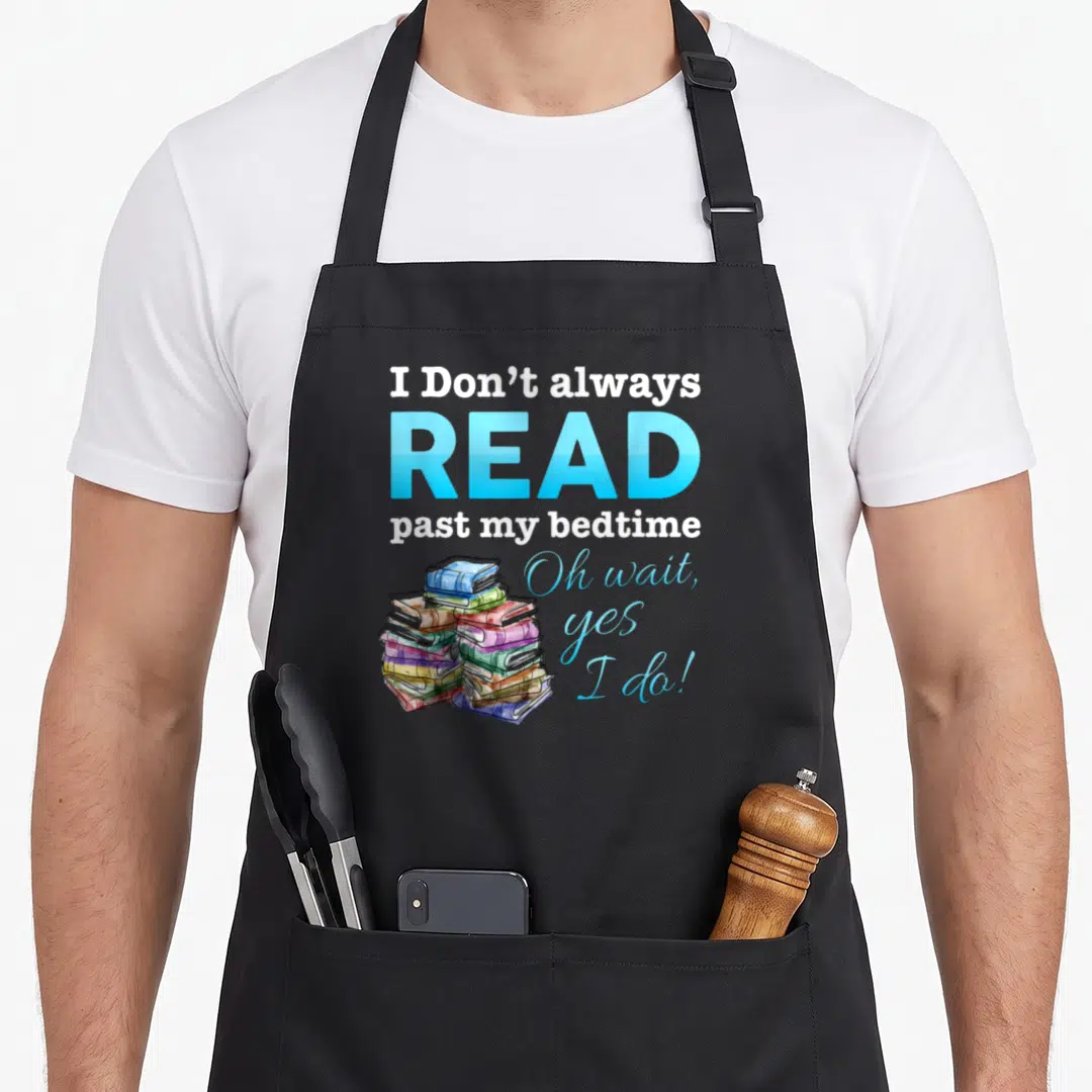Alway i love reading apron - Stacked colorful books with typography reading I Don't always READ past my bedtime — shown on a black cotton canvas apron against a white background
