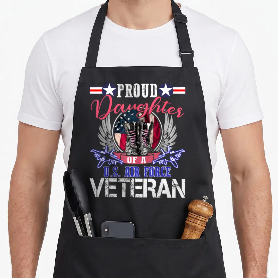 Daughter air force veteran apron - PROUD Daughter OF A U.S. AIR FORCE VETERAN with boots and wings — shown on a black cotton canvas apron against a white background