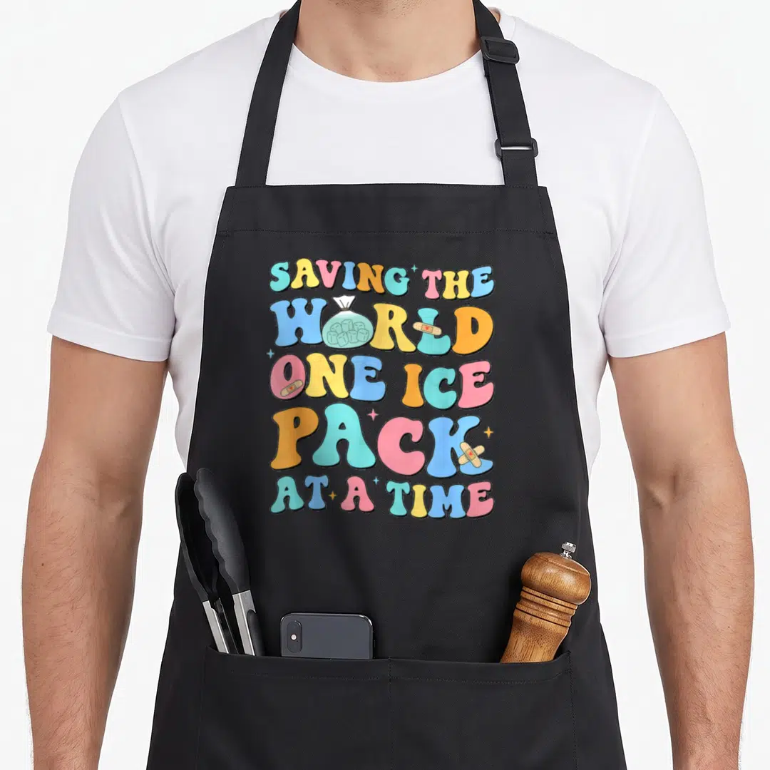Saving ice nurse apron - Stacked multi-colored text with ice pack graphic and scattered bandages — shown on a black cotton canvas apron against a white background