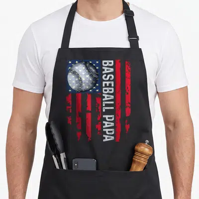 Coach father day apron - Distressed baseball over blue canton with vertical BASEBALL PAPA text and red stripes — shown on a black cotton canvas apron against a white background