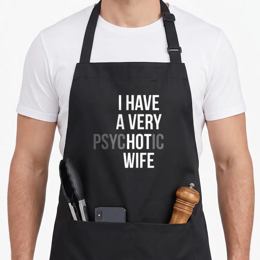 Married wife apron - Stacked white and grey text reading I HAVE A VERY PSYCHOTIC WIFE with HOT highlighted — shown on a black cotton canvas apron against a white background