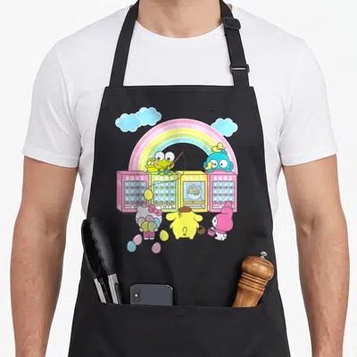 Hello easter apron - Sanrio characters around four colorful egg vending machines under a rainbow with EGGS text — shown on a black cotton canvas apron against a white background