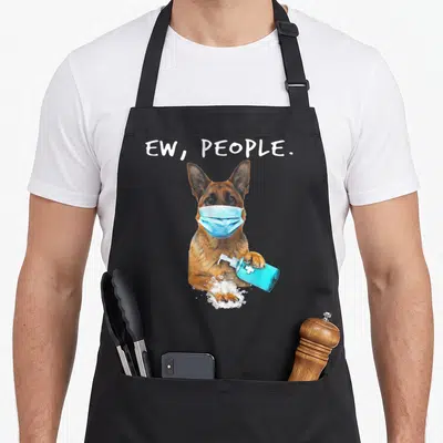 German dog face apron - Cartoon German Shepherd in blue mask holding soap dispenser with text EW PEOPLE — shown on a black cotton canvas apron against a white background