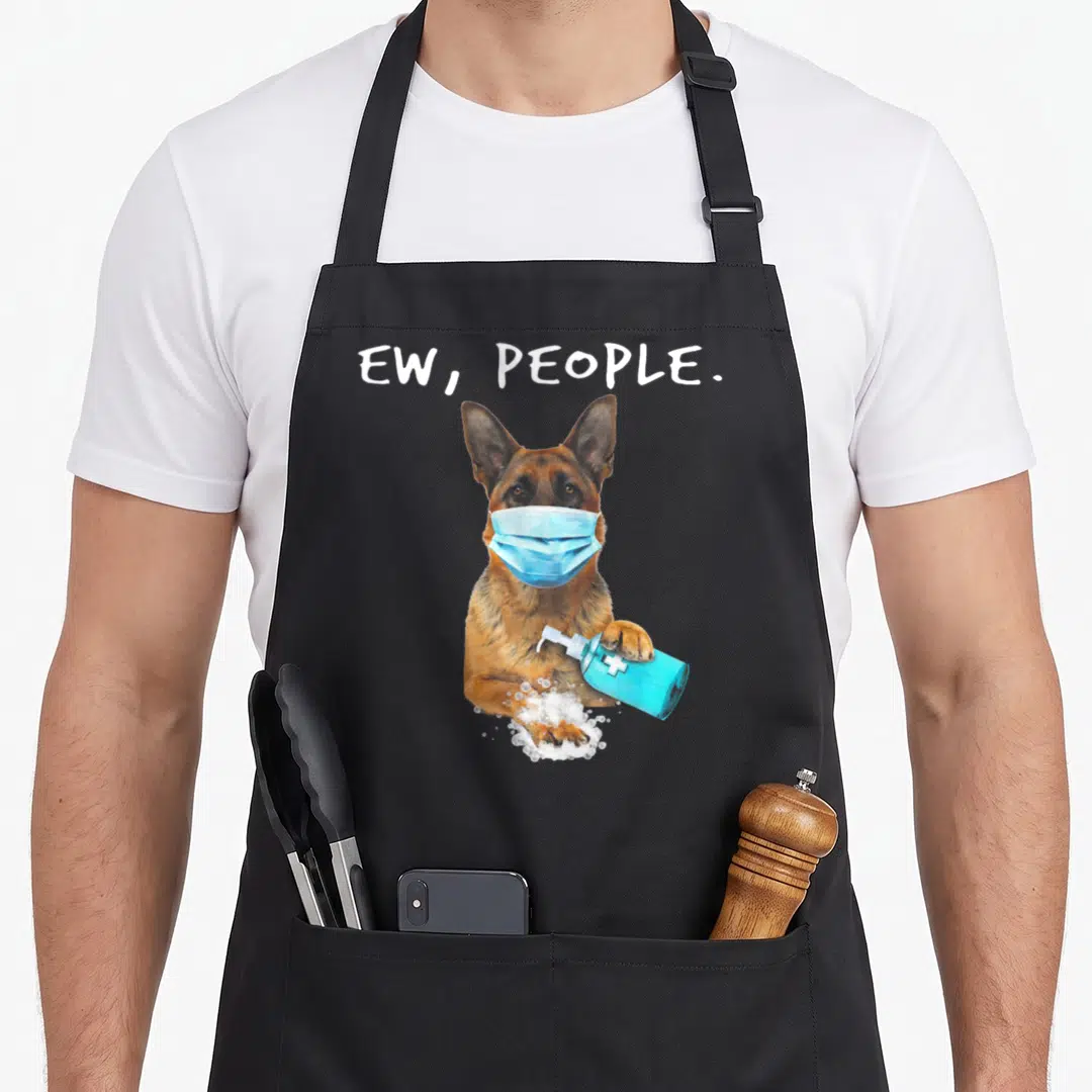 German dog face apron - Cartoon German Shepherd in blue mask holding soap dispenser with text EW PEOPLE — shown on a black cotton canvas apron against a white background