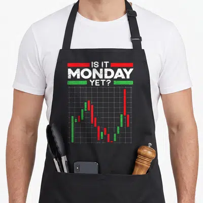 Marker stock aprons - Distressed IS IT MONDAY YET text above red and green candlestick chart on grid — shown on a black cotton canvas apron against a white background