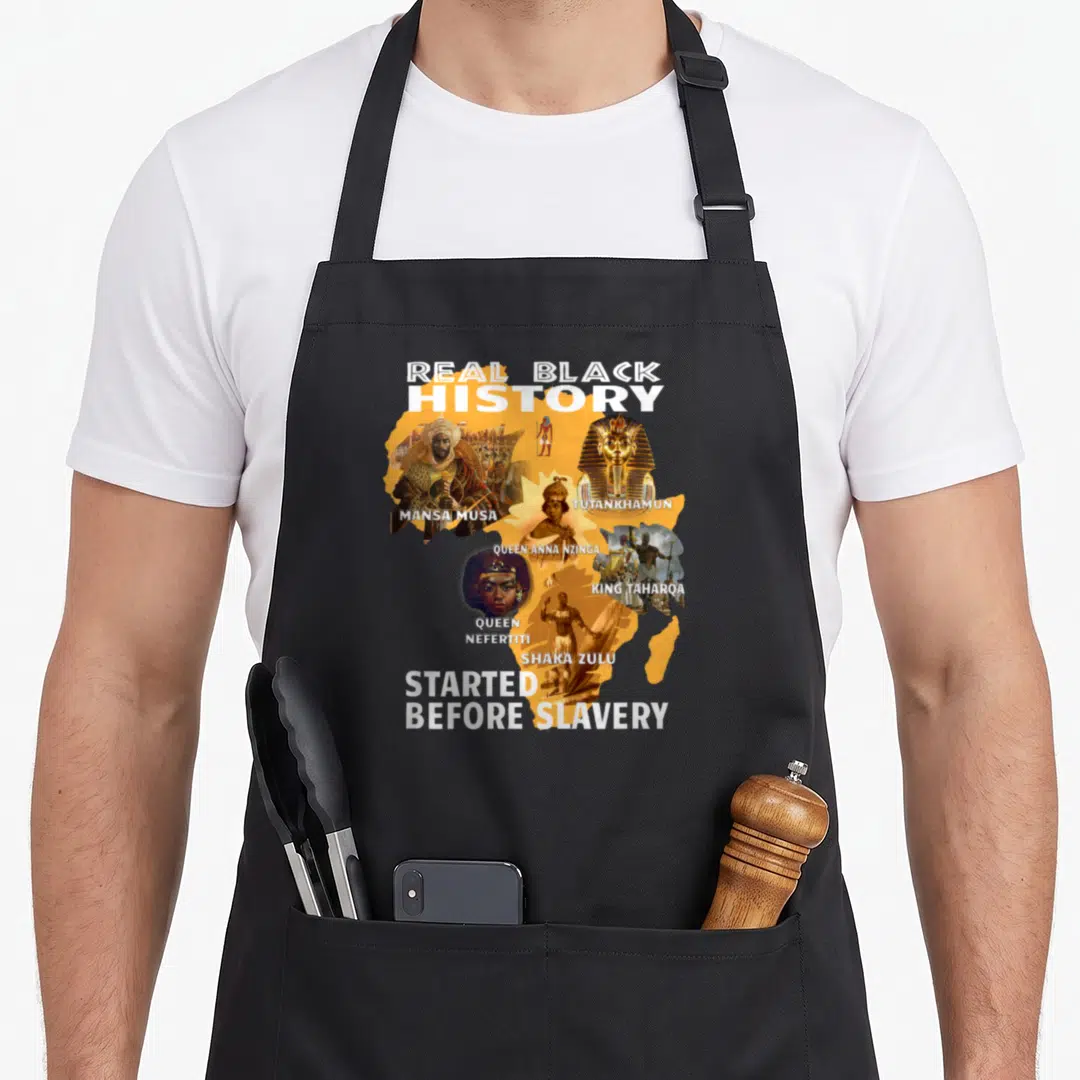 Didnt black history apron - Orange Africa map collage with Mansa Musa Tutankhamun Nzinga Nefertiti Taharoa Zulu text — shown on a black cotton canvas apron against a white background