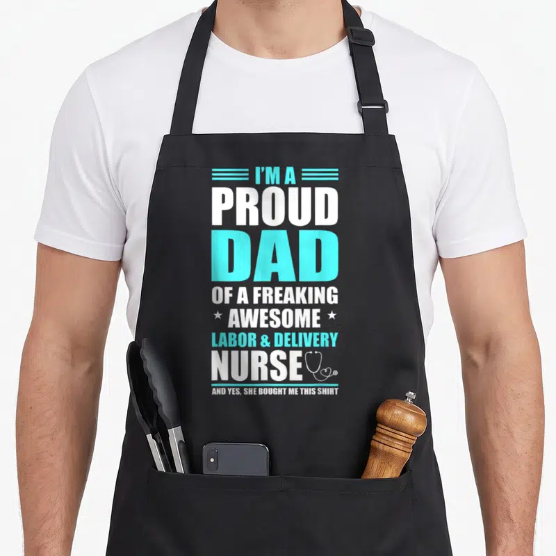 Freaking nurse apron - Stacked text proud dad nurse with cyan lines and white stethoscope graphic — shown on a black cotton canvas apron against a white background