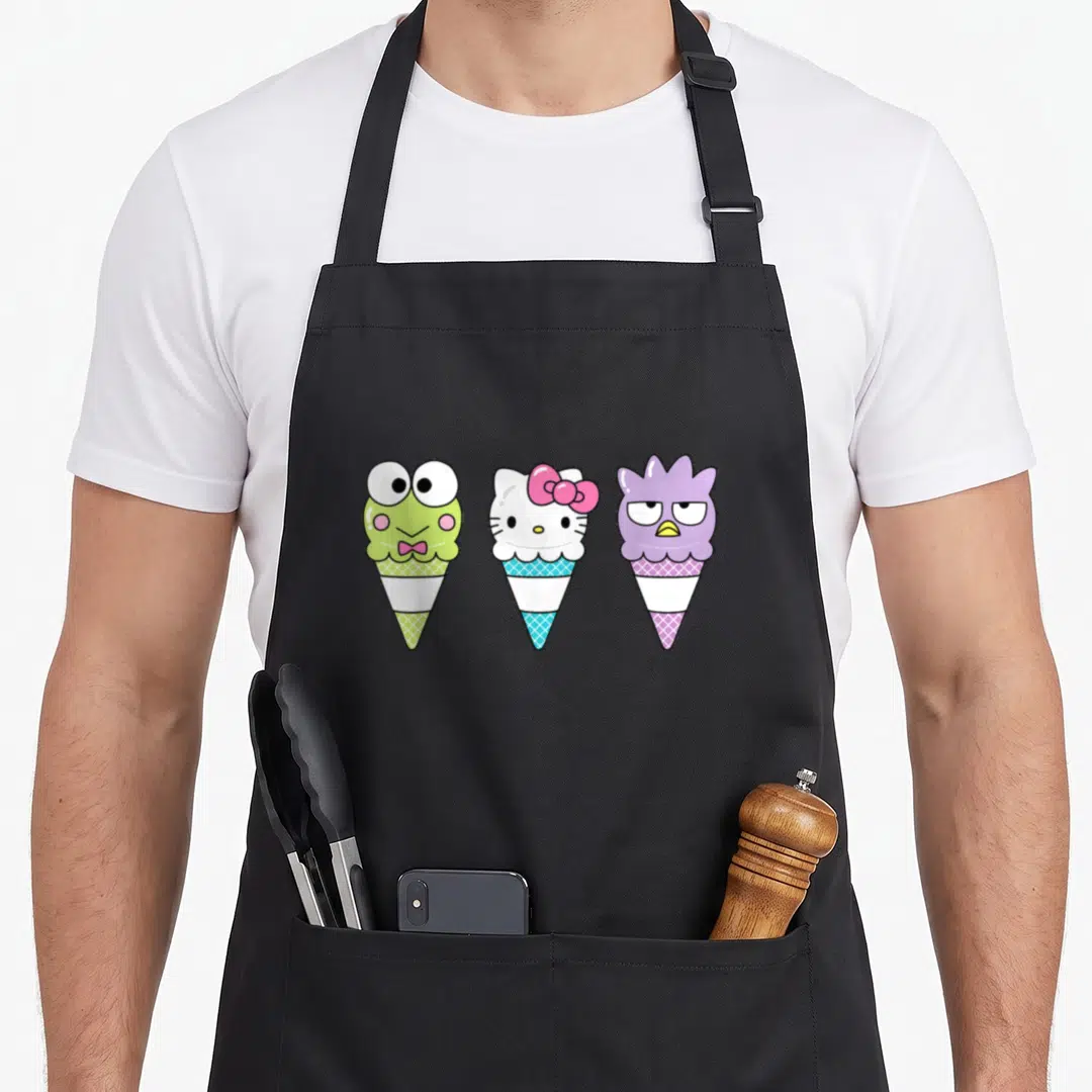 Keroppi ice cream apron - Three cartoon ice cream cones in green, blue, and purple with waffle cone details — shown on a black cotton canvas apron against a white background