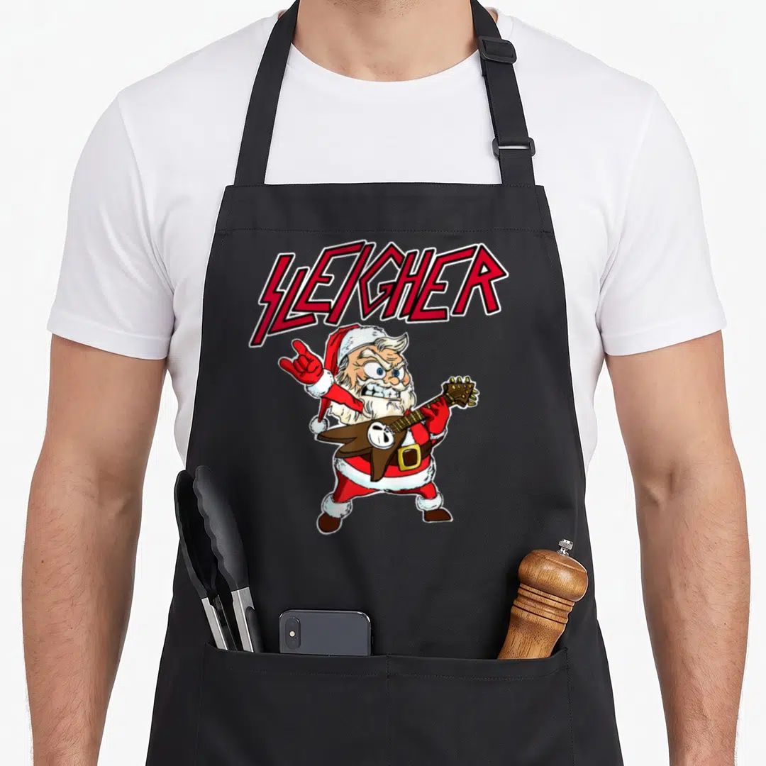 Sleigher santa claus apron - Cartoon Santa playing spiked guitar under arched red SLEIGHER text — shown on a black cotton canvas apron against a white background