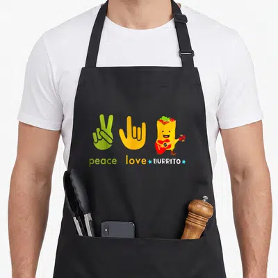 Fan mexican apron - Cartoon burrito playing guitar next to peace and love hand signs with matching text — shown on a black cotton canvas apron against a white background