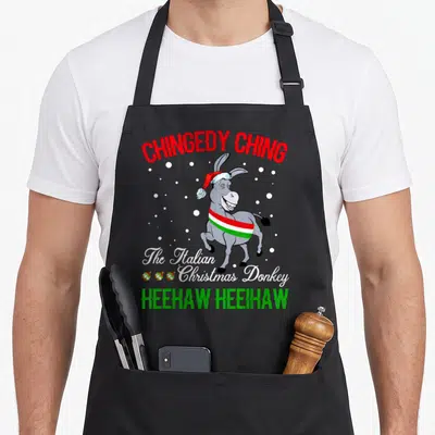 Italian christmas apron - Cartoon grey donkey wearing red Santa hat and Italian flag sash with red and green text — shown on a black cotton canvas apron against a white background