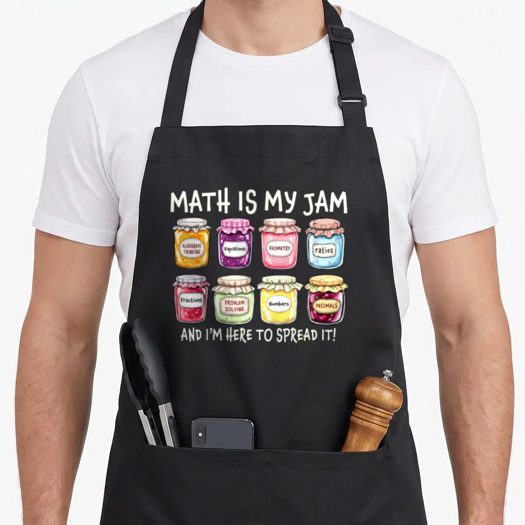Spread teacher apron - Eight colorful jam jars labeled with math terms under Math Is My Jam text — shown on a black cotton canvas apron against a white background