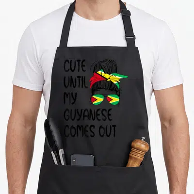 Come guyana apron - Stacked text next to woman with Guyanese flag headband and sunglasses in cartoon style — shown on a black cotton canvas apron against a white background