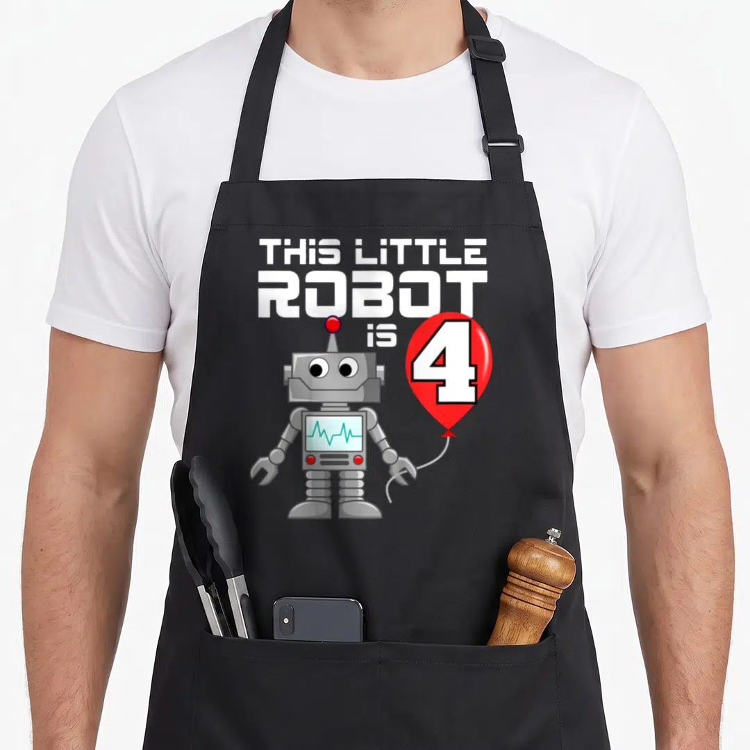 Robot birthday apron - Grey cartoon robot holding a red balloon with the number 4 next to white stacked text — shown on a black cotton canvas apron against a white background