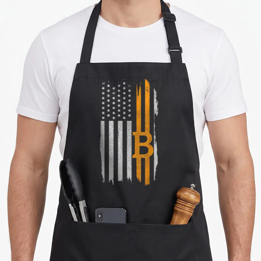 Bitcoin american flag apron - Distressed white and orange flag with vertical stripes and integrated B symbol — shown on a black cotton canvas apron against a white background