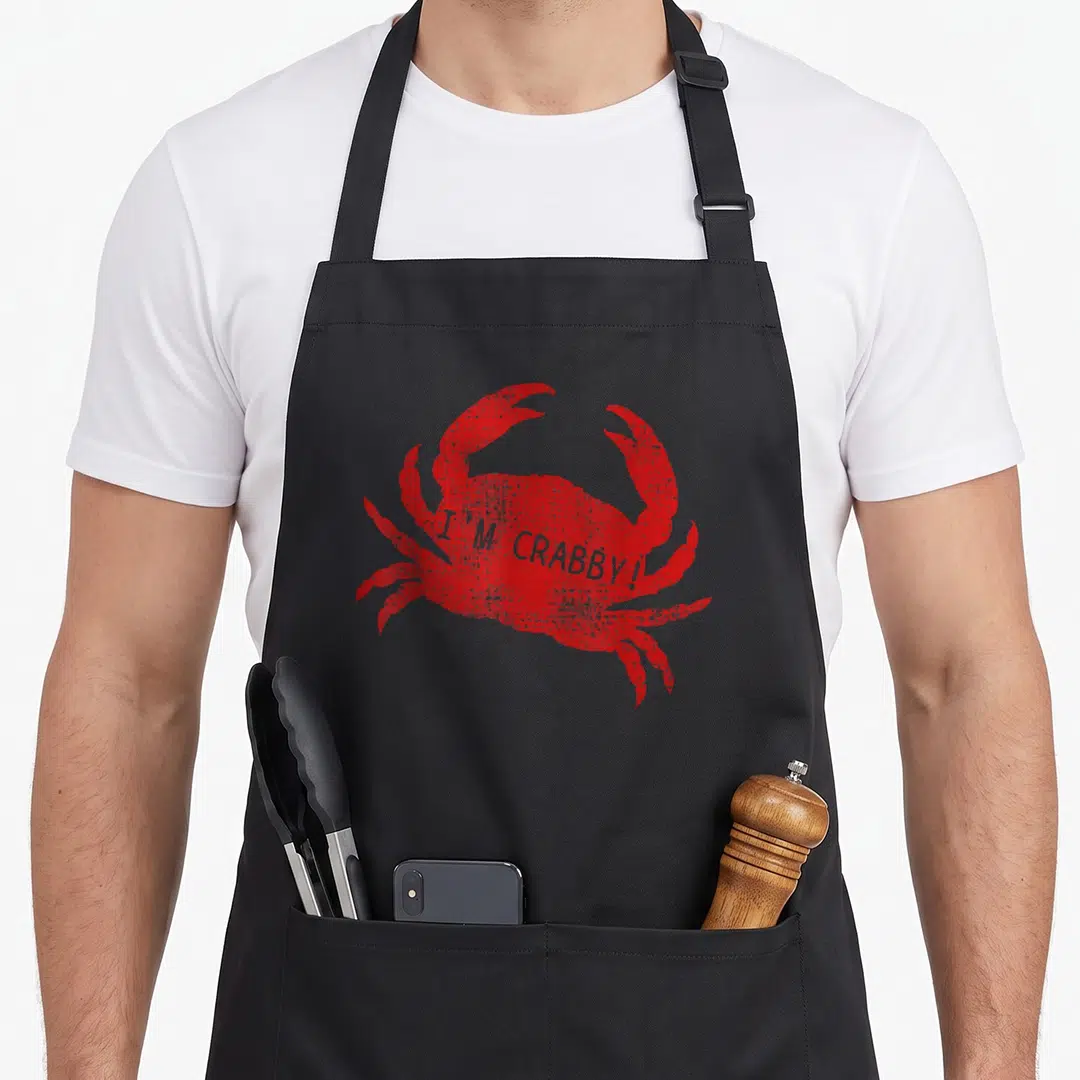 Sea crab apron - Red distressed crab with I'M CRABBY! text overlay — shown on a black cotton canvas apron against a white background
