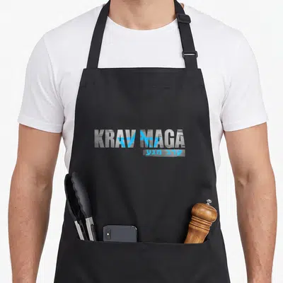Krav combat apron - Distressed grey KRAV MAGA text with blue geometric overlays and Hebrew script — shown on a black cotton canvas apron against a white background