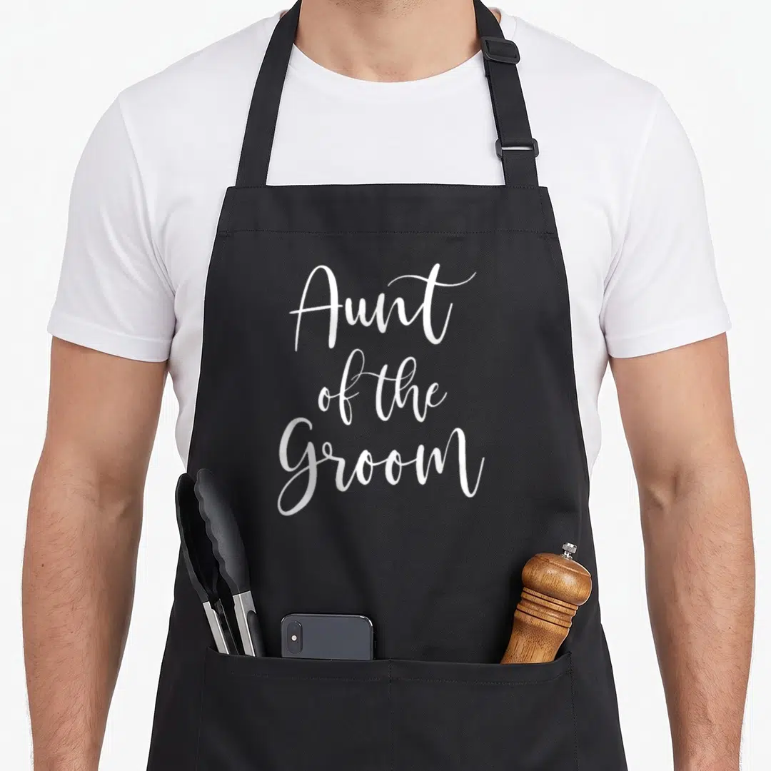 Bridal wedding day aprons - White cursive text reading Aunt of the Groom stacked on three lines — shown on a black cotton canvas apron against a white background