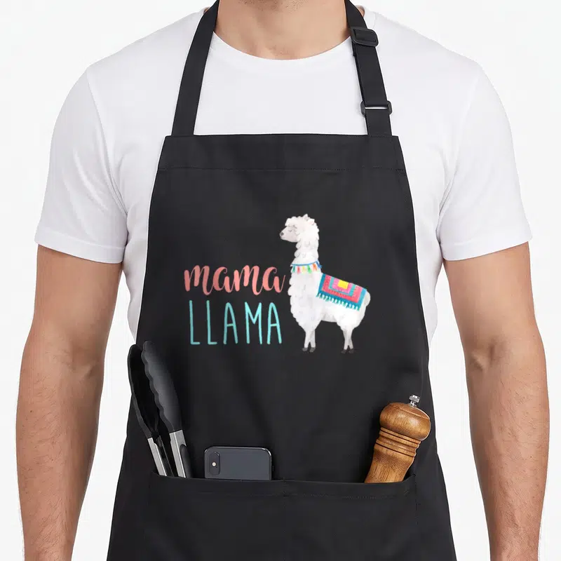 Animal mama apron - White watercolor llama standing beside pink and blue text reading mama LLAMA — shown on a black cotton canvas apron against a white background