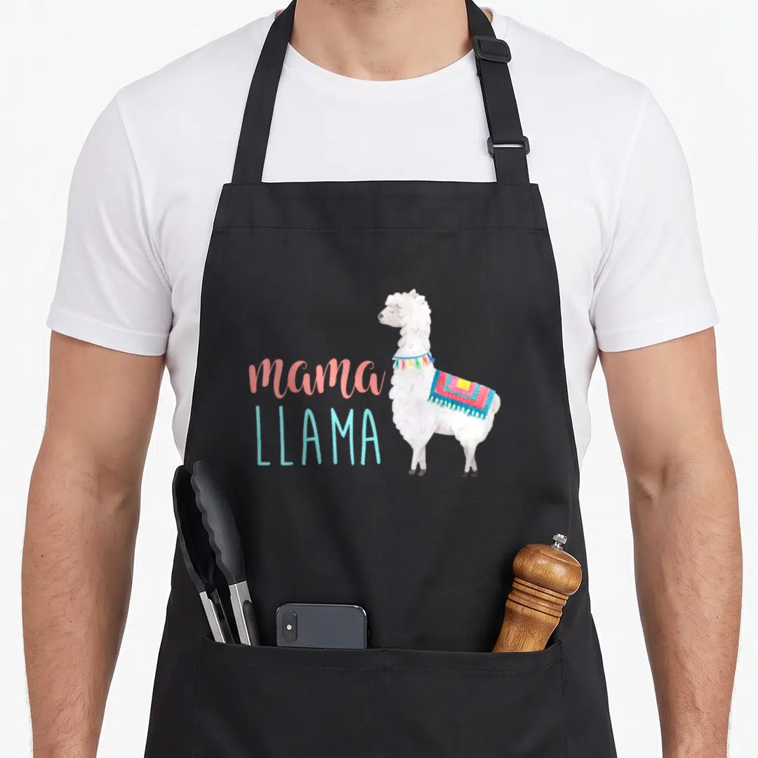 Animal mama apron - White watercolor llama standing beside pink and blue text reading mama LLAMA — shown on a black cotton canvas apron against a white background