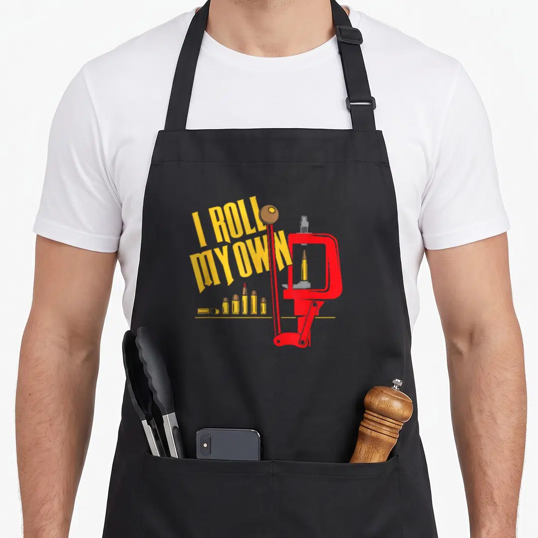 Patch patriots apron - Yellow I ROLL MY OWN text over red reloading press with bullets on bottom line — shown on a black cotton canvas apron against a white background