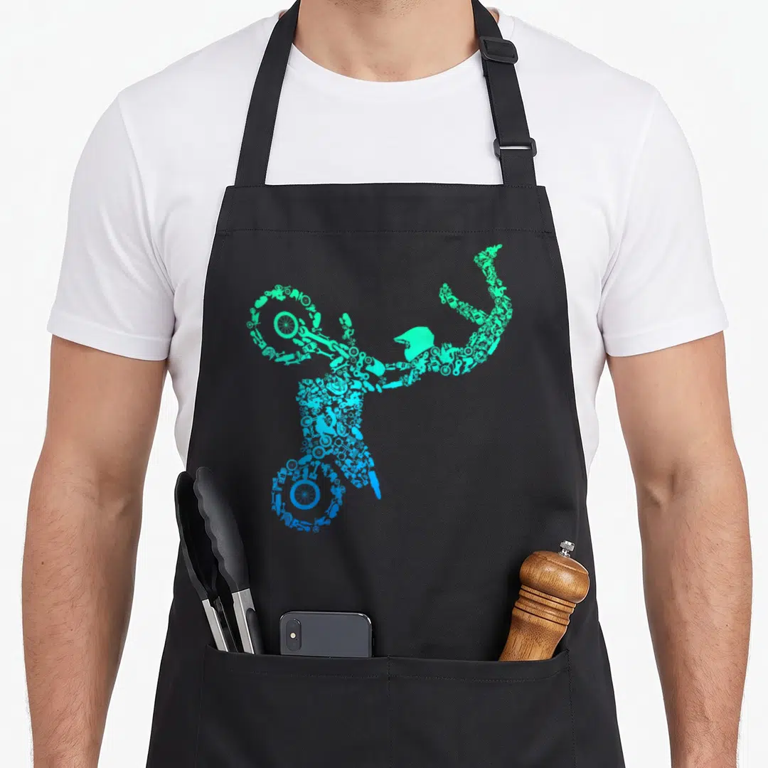 Supermoto bike apron - Motorcycle silhouette made of tools in green blue cyan gradient — shown on a black cotton canvas apron against a white background